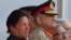 n this March 23, 2019 photo, Pakistan's Army Chief Gen. Qamar Javed Bajwa, center, watches a parade with Prime Minister Imran Khan, left, and President Arif Alvi, in Islamabad, Pakistan. 