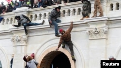 Supporters of U.S. President Donald Trump climb on walls at the U.S. Capitol during a protest against the certification of the 2020 U.S. presidential election results by the U.S. Congress, in Washington, U.S., January 6, 2021.