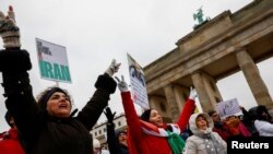 People take part in a protest against the Islamic regime of Iran following the death of Mahsa Amini, in Berlin, Germany, Dec. 10, 2022. 