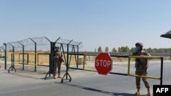 Uzbek soldiers guard a checkpoint near Friendship Bridge over the Amu Darya River, which separates Uzbekistan and Afghanistan, Termez, Uzbekistan, Aug. 15, 2021.