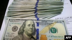 Pialang penukaran mata uang mempersiapkan transaksi mata gang US dolar, 1 Januari 2020. (Foto: AFP)