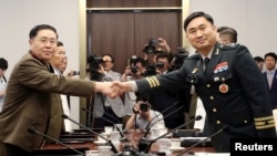 North Korean Lieutenant General An Ik San shakes hands with South Korean Major General Kim Do-gyun during a meeting at the Peace House of the border village of Panmunjom, South Korea, July 31, 2018. 