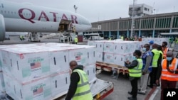FILE - Officials receive boxes of Moderna coronavirus vaccine at the airport in Nairobi, Kenya, Sept. 6, 2021. 
