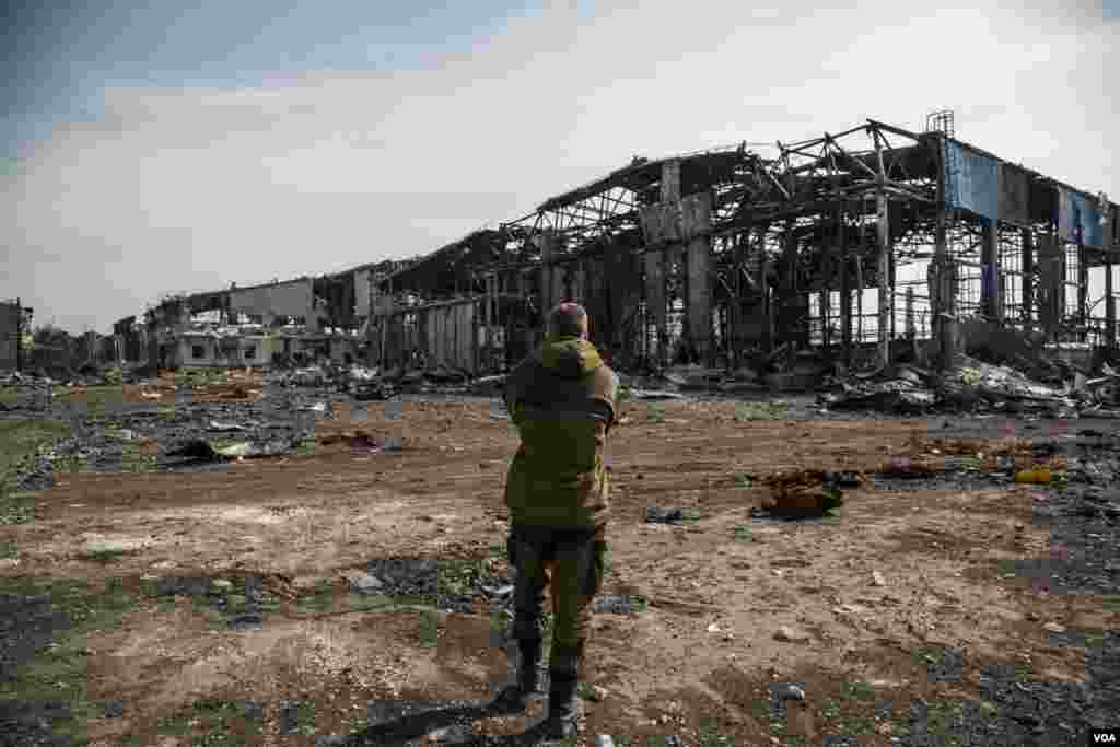 A pro-Russian fighter walks through what remains of the rebel-held Donetsk airport, after intense fighting. (Adam Bailes/VOA)