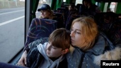 Alla Yatsentiuk embraces her 14-year-old son Danylo, who was taken to Russia, after returning via the Ukraine-Belarus border, in Volyn region Ukraine April 7, 2023. (REUTERS/Valentyn Ogirenko)
