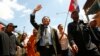 Cambodia's main opposition Cambodia National Rescue Party Vice President Kem Sokha, center, waves during a protest rally in Phnom Penh, Cambodia, May 20, 2013. 