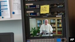 Pope Francis is seen on a video screen at U.N. headquarters as he speaks in a pre-recorded message addressing the 75th session of the General Assembly, Sept. 25, 2020. 
