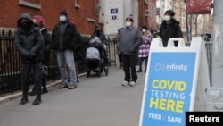 People queue for a COVID-19 test as the Omicron coronavirus variant continues to spread, in Manhattan, New York City, Dec. 21, 2021.