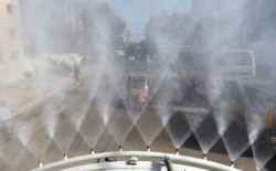 A truck sprays disinfectant along a street following the spread of coronavirus disease (COVID-19) in Karachi, Pakistan, April 9, 2020.