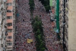 Protesters march during a rally against a controversial extradition law proposal in Hong Kong.
