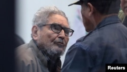 Shining Path founder Abimael Guzman attends a trial during sentence of a 1992 Shining Path car bomb case in Miraflores, at a high security naval prison in Callao, Peru, Sept. 11, 2018.