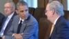 FILE - President Barack Obama, center, looks at then-Senate Minority Leader Mitch McConnell (R-KY) in the Cabinet Room of the White House, Washington, July 31, 2014.