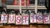 People hold placards to form the word "Justice" during a protest against the military coup in Yangon, Myanmar, Feb. 22, 2021. 