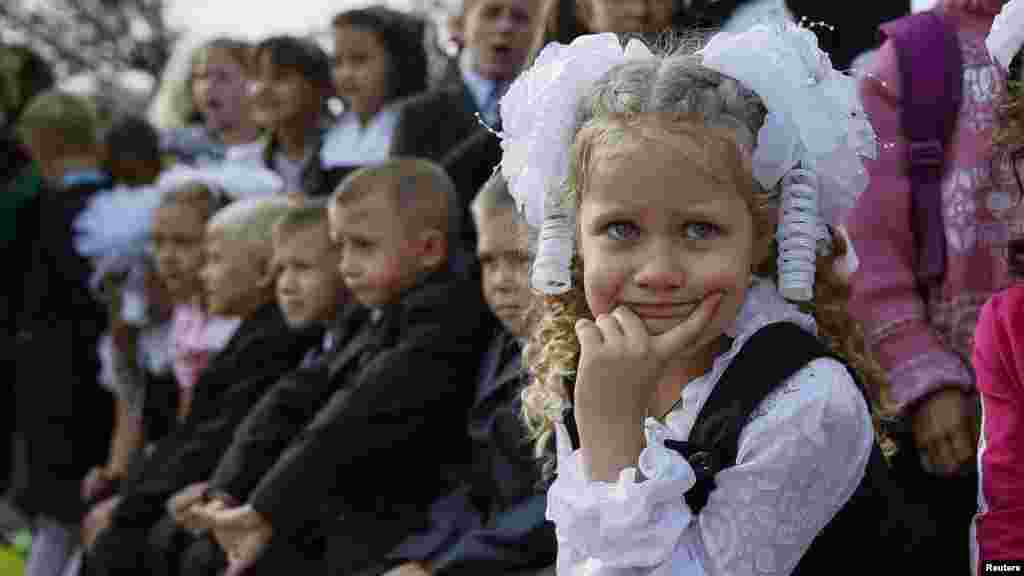First-graders attend a festive ceremony to mark the start of another school year in Slovyansk, Ukraine, Sept. 1, 2014. 
