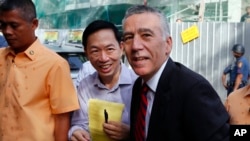 FILE - U.S. Ambassador to the Philippines Philip Goldberg, right, arrives for a forum, Feb. 3, 2016 at suburban Quezon city, northeast of Manila, Philippines. 