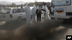 In this Wednesday, Oct. 16, 2019. photo, smoke comes out from silencer of an old mini-bus in Kabul, Afghanistan. Most days a layer of smog covers Kabul, and it gets worse in the winter, when people burn coal, garbage, plastic and rubber to heat their home