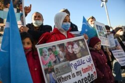 Members of Uighur minority demonstrate to ask for news of their relatives and to express their concern about the ratification of an extradition treaty between China and Turkey, Feb. 22, 2021, near China consulate in Istanbul.