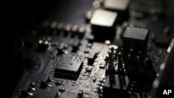 This Feb 23, 2019, file photo shows the inside of a computer in Jersey City, N.J. (AP Photo/Jenny Kane, File)