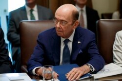 FILE - U.S. Commerce Secretary Wilbur Ross listens during a Cabinet meeting in the Cabinet Room of the White House, July 16, 2019, in Washington.