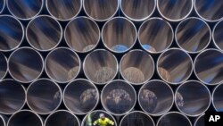 FILE - Tubes are stored in Sassnitz, Germany, to construct the natural gas pipeline Nord Stream 2 from Russia to Germany, Dec. 6, 2016.