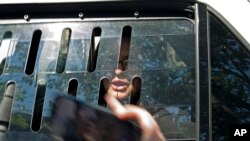 A pro Nicolas Maduro supporter Adrienne Pine is arrested, during the eviction of Maduro's supporters from the Venezuelan Embassy in Washington, May 16, 2019.
