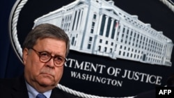 (FILES) In this file photo taken on January 13, 2020 US Attorney General William Barr holds a press conference regarding the December 2019 shooting at the Pensacola Naval air station in Florida at the Department of Justice in Washington, DC. - US…