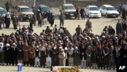 Afghans pray during the funeral of a victim who was killed in Saturday's deadly suicide attack in Kabul, Afghanistan, Jan. 28, 2018. 