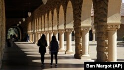 In this March 14, 2019, file photo students walk on the Stanford University campus in Santa Clara, California.