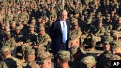 FILE - Defense Secretary Jim Mattis talks to U.S. troops at Guantanamo Bay, Cuba, Dec. 21, 2017.