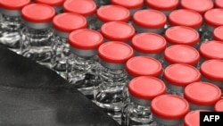 FILE - Capped vials are shown during filling and packaging tests for the large-scale production and supply of the University of Oxford’s COVID-19 vaccine candidate, AZD1222, on Sept. 11, 2020, in Italy. (AFP)