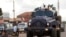 FILE - Riot police patrol the streets in Kampala, Uganda.