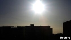 FILE - The sun's rays in Seville, Spain.