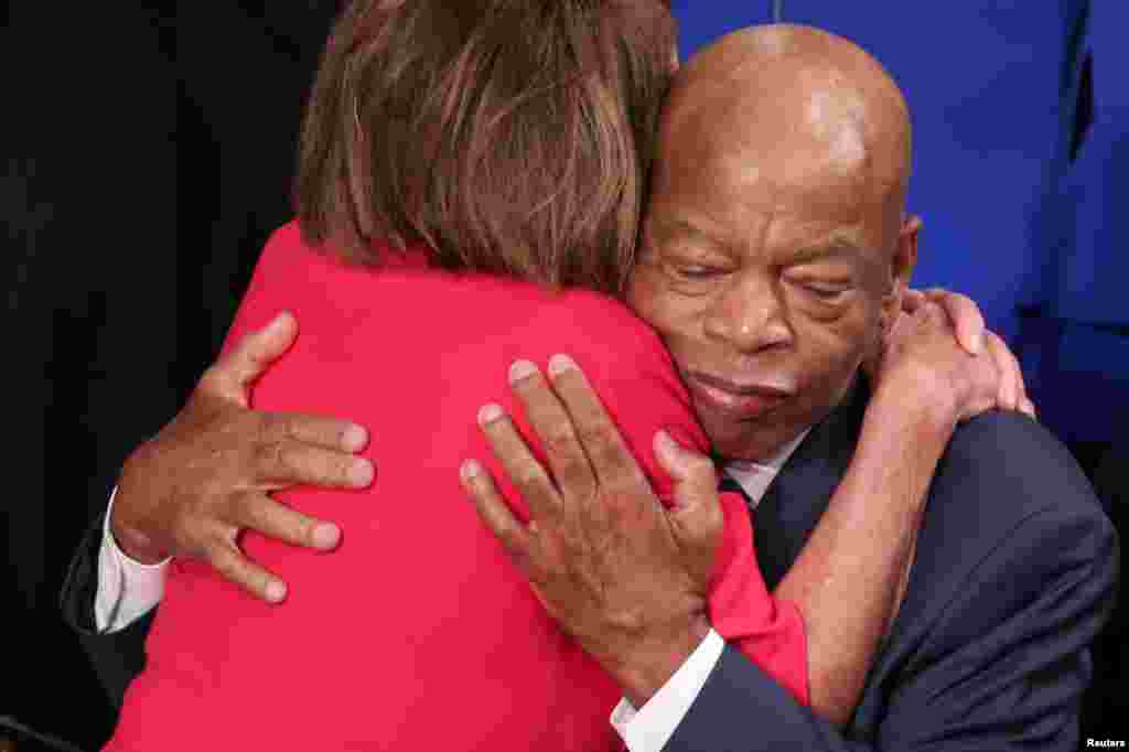 House Democratic leader Nancy Pelosi (D-CA) is embraced by U.S. Rep. John Lewis (D-GA) inside the House Chamber as the U.S. House of Representatives meets for the start of the 116th Congress on Capitol Hill in Washington, Jan. 3, 2019. 