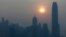 FILE - The skyline of the business district is silhouetted at sunset in Hong Kong.