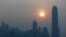 FILE - The skyline of the business district is silhouetted at sunset in Hong Kong.