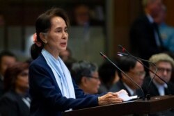 FILE - Myanmar's leader Aung San Suu Kyi addresses judges of the International Court of Justice for the second day of three days of hearings in The Hague, Netherlands, Dec. 11, 2019.