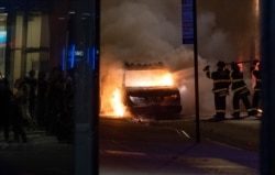 A vehicle burns near New York's Union Square, May 30, 2020, as police confronted protesters.
