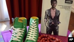 Green casual shoes and a red beaded necklace on show at a fashion range launch, inspired by South African President Nelson Mandela's 94th birthday in Johannesburg, June 29, 2012. 