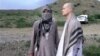 FILE - In this image taken from video obtained from the Voice of Jihad website in June 2014, Army Sgt. Bowe Bergdahl, right, stands with a Taliban fighter in eastern Afghanistan.