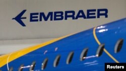 FILE - The logo of Brazilian planemaker Embraer SA is seen at the company's headquarters in Sao Jose dos Campos, Brazil, Feb. 28, 2018.