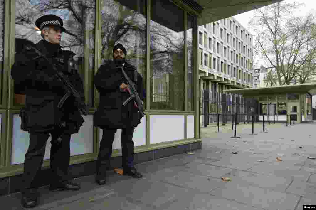 Police officers stand vigilant outside the U.S. embassy in London as the Senate Intelligence Committee prepares to release a report on the CIA&#39;s anti-terrorism tactics, Dec. 9, 2014.