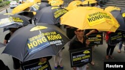 Activists in support of the pro-democracy demonstrations in Hong Kong protest in front of the Chinese Consular office in Makati city, metro Manila, Oct. 2, 2014.
