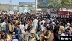 People try to get into Hamid Karzai International Airport in Kabul, Afghanistan, Aug. 16, 2021. 