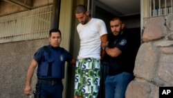 FILE - Police arrest a man in connection with a double-murder, in Mendoza, Argentina, Jan. 26, 2019.