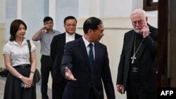 Vietnamese Foreign Minister Bui Thanh Son, second from right, welcomes the Vatican's foreign minister, Paul Gallagher, right, at the Foreign Ministry in Hanoi on April 9, 2024.