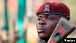 A Kenya General Service Unit policeman stands guard in the area around Westgate shopping mall in Nairobi, Sept. 25, 2013.