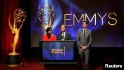 Television Academy Chairman & CEO Bruce Rosenblum (C), actress Mindy Kaling (L) and television host Carson Daly (R) stand together during the nominations announcement for the 66th Primetime Emmy Awards in North Hollywood, California, July 10, 2014.