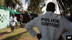 Forensic scientists and doctors prepare for the exhumation of a mass grave site on the grounds of a mosque, in the Yopougon district of Abidjan, Ivory Coast, April 4, 2013.