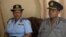 Zimbabwe police spokesperson, Charity Charamba (left), and Erasmus Makodza, the head of the new election command within Zimbabwe’s police force (right), speaking to reporters in Harare, Apr. 23, 2018. 