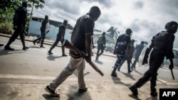 Gabonese police forces patrol as they clear barricades in the streets adjacent to the National Assembly, in Libreville, Sept. 1, 2016.